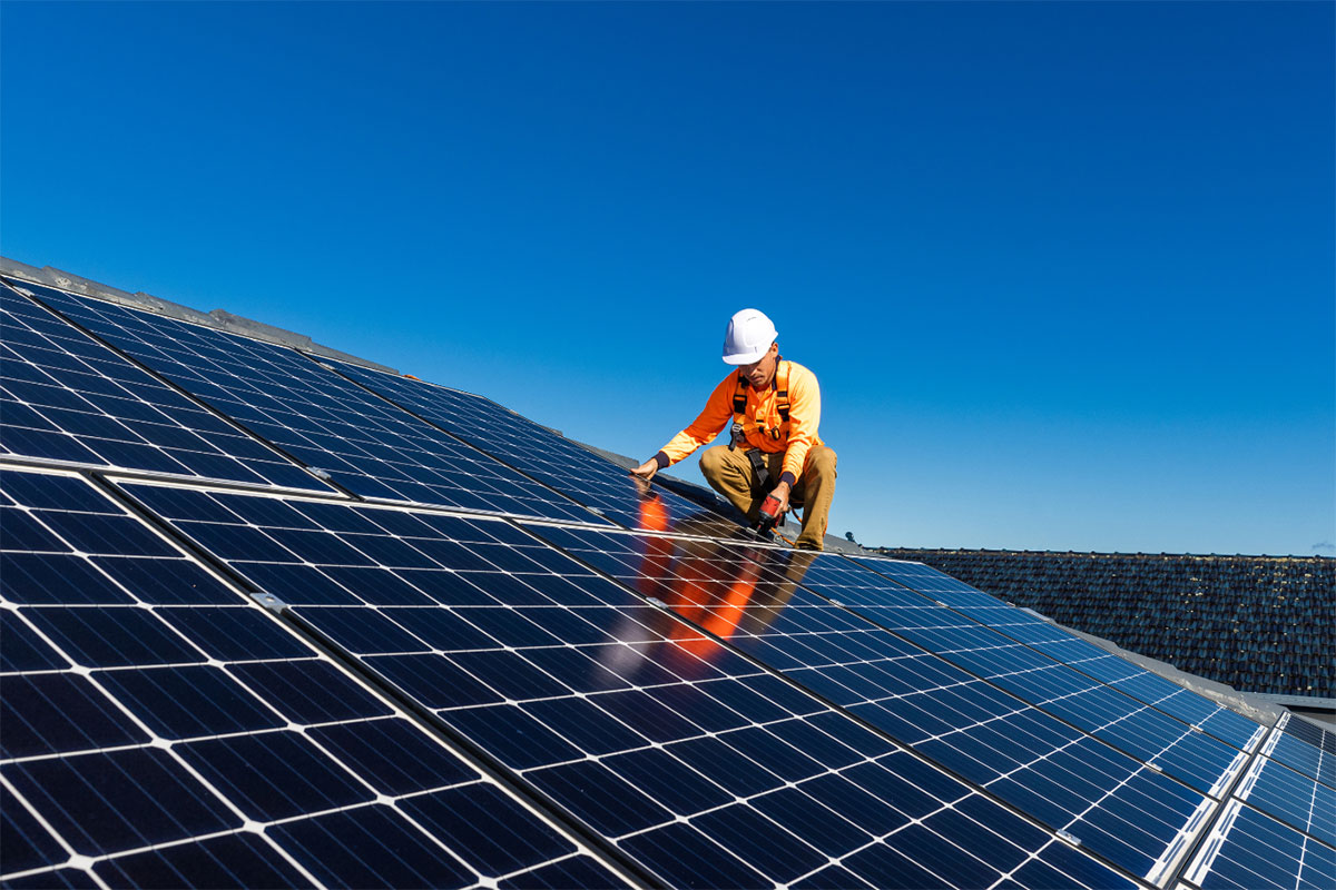 Worker installing solar panels