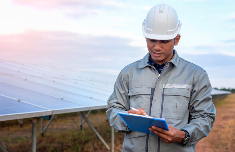 Man on solar panel field